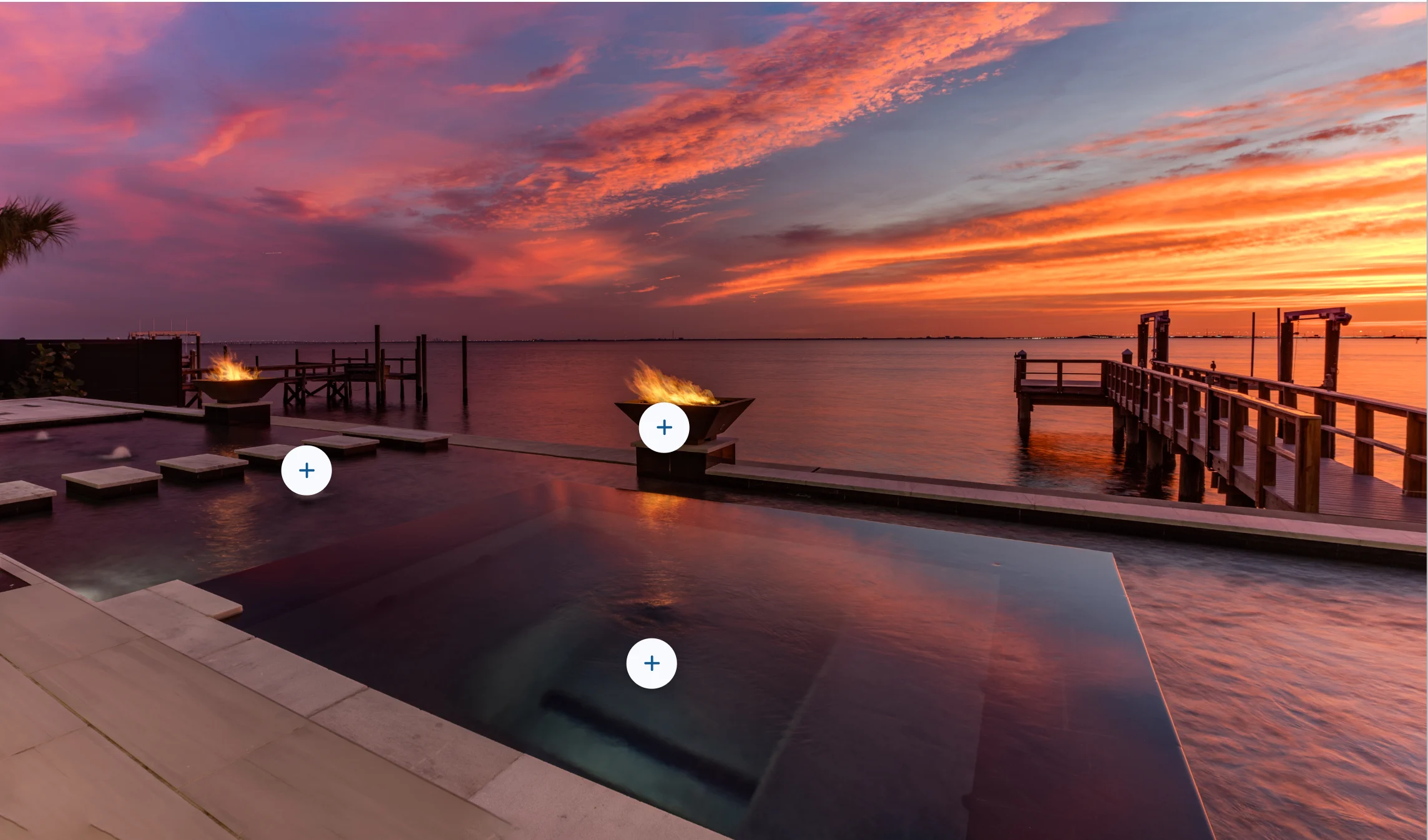 A Scene presentation: a finished pool at sunset with tappable hotspots over the fire bowls and water features